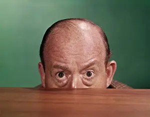 Desktop: 1960s Balding Man Peeking Over