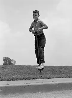 Pogo: 1960s Boy Jumping On Pogo Stick
