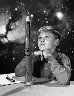 Diligent: 1960s BOY WITH MODEL ROCKET AND OUTER SPACE BACKGROUND