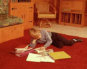 Shag: 1960s Boy Reading Studying Homework Lying on Red Shag Car