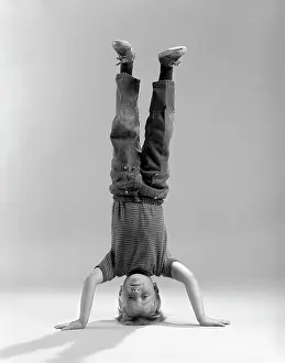 Topsy: 1960s Boy Standing on his Head looking at Camera