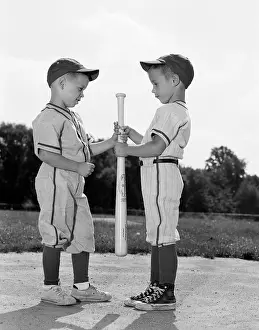 Sandlot: 1960s Two Boys In Baseball Uniforms Choosing Sides By Gettin