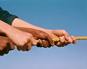 Aching: 1960s CAUCASIAN AND AFRICAN AMERICAN HANDS PULLING