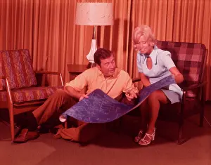 Middleaged: 1960s Couple Holding Blueprints