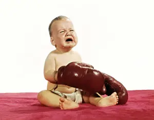 Sobbing: 1960s crying baby wearing boxing