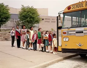 Bussing: 1960s Group Of Elementary Kids In Line Getting Onto Yellow S