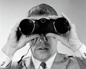 1960s HEAD-ON CLOSE-UP OF MAN LOOKING THROUGH