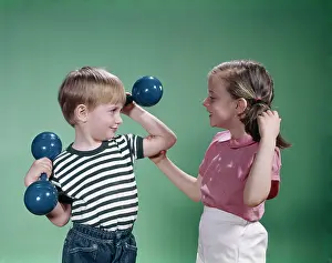 Strongman: 1960s Little Boy Lifting Hand