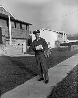 Mailman: 1960s MAILMAN WALKING OUTSIDE CARRYING MAIL ON
