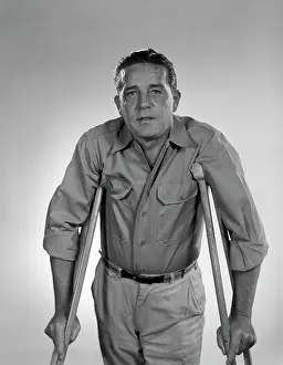 Sufferer: 1960s Man On Crutches