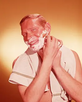 Shaves: 1960s Man Looking As If In Bathroom