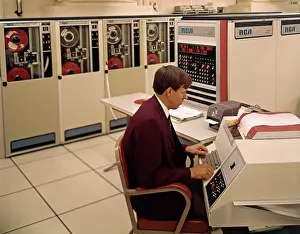 Programming: 1960s Man Programmer Entering Data on System Console Keyb