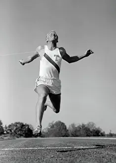 Sprinting: 1960s MAN RUNNING WINNING SPRINTING ACROSS THE
