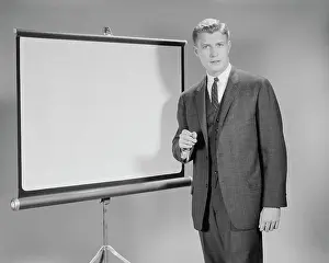 Audiovisual: 1960s MAN STANDING BESIDE BLANK SCREEN READY