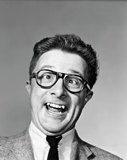 Agitated: 1960s Man Wearing Black Plastic