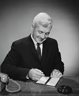 Checkbook: 1960s MAN WRITING CHECK FROM CHECKBOOK