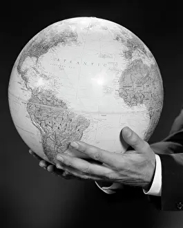 Intercontinental: 1960s MANS HAND HOLDING GLOBE OF THE WORLD