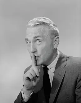 Shush: 1960s MIDDLE AGED MAN FINGER TO LIPS MAKING QUIET