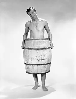 Midsection: 1960s Naked Man With Barrel Around
