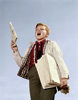 Hawking: 1960s paperboy with stack newspapers under his