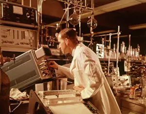 Oscilloscope: 1960s SCIENTIST LAB TECHNICIAN LOOKING INTO OSCILLOSCOPE