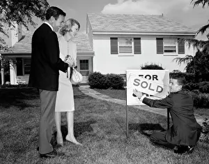 Realtor: 1960s Smiling Couple Standing