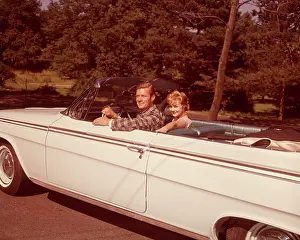 Convertibles: 1960s Smiling Couple White Convertible