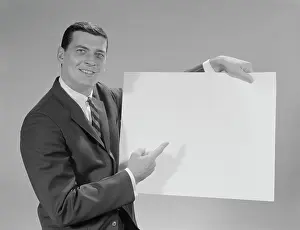 Spokesperson: 1960s SMILING MAN POINTING TO BLANK POSTER