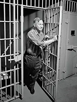 Correctional: 1960s smiling middle aged man prisoner convict