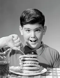 Pancakes: 1960s Smiling Portrait Boy Sitting