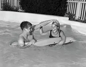 Dunk: 1960s Teen Couple In Pool Floating