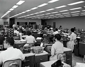 Typists: 1960s Back View Of Men And Women