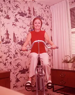 Pedaling: 1960s Woman On Exercise Cycle