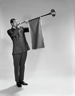 Trumpeting: 1960s Young Man Standing Blowing