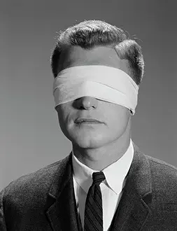 Senses: 1960s YOUNG MAN WEARING BLINDFOLD