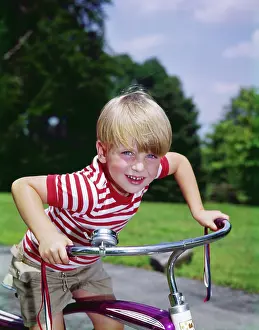 Aerobic: 1970s 1960s Smiling Blond Boy Leaning Over Handlebars Of Bic