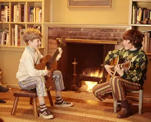 Strumming: 1970s 2 Boys Front Fireplace Play