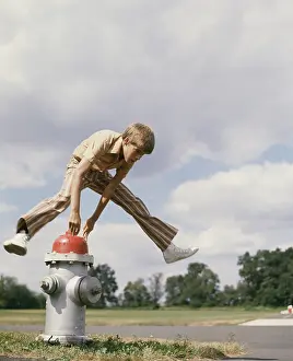 Hydrant: 1970s BOY JUMPING OVER FIRE HYDRANT