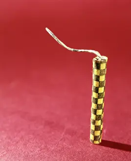 Firecracker: 1970s SINGLE YELLOW FIRECRACKER FUSE RED BACKGROUND