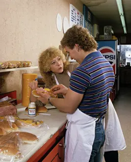Scolded: 1980s 1990s YOUNG MAN WORKING MAKING SANDWICH