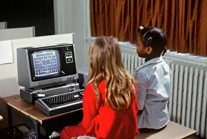 High Tech: 1980s Two Girls Learning About Computers by Playing on Sc
