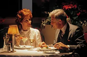Lamplight: 1980s middle aged couple dining romantic