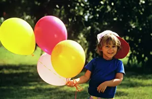 Tay001: 1990s BOY OUTDOORS HOLDING BALLOONS LOOKING AT