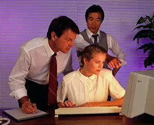 Desktop: 1990s business people working together at computer