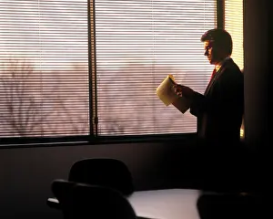 Bar007: 1990s executive with legal pad by window
