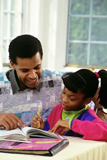 Afro American: 1990s Father Helping Daughter with her Homework