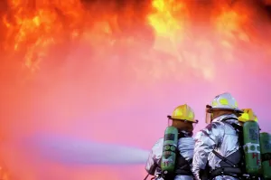 Conflicting: 1990s firefighters training at fire pit