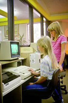 Networking: 2 Girls Working on Computer in Public Library