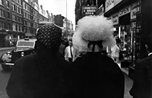 Netted: 2 ladies in fancy hat and headscarf
