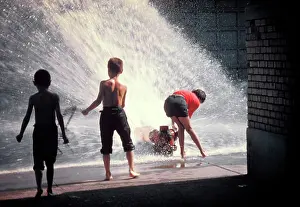 Hydrant: 3 Anonymous Children Playing in Water Sprayed